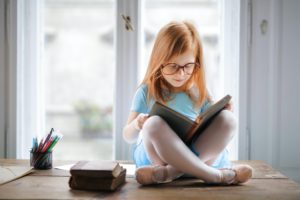 girl reading in a window
