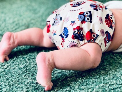 baby in sustainable nappy legs crawling