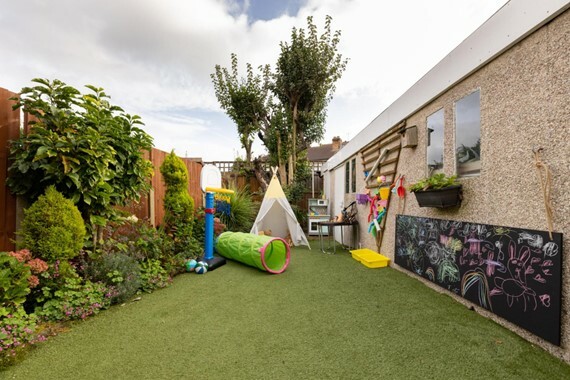 childminder outdoor garden play area with teepee and toys