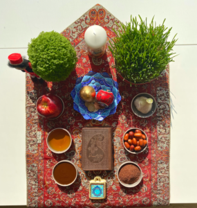 Nowruz table set with symbolic dishes and objects