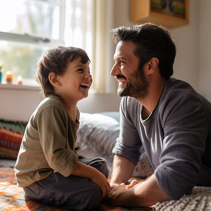 A dad and child sitting together, enjoying a moment of presence and active listening without screen time