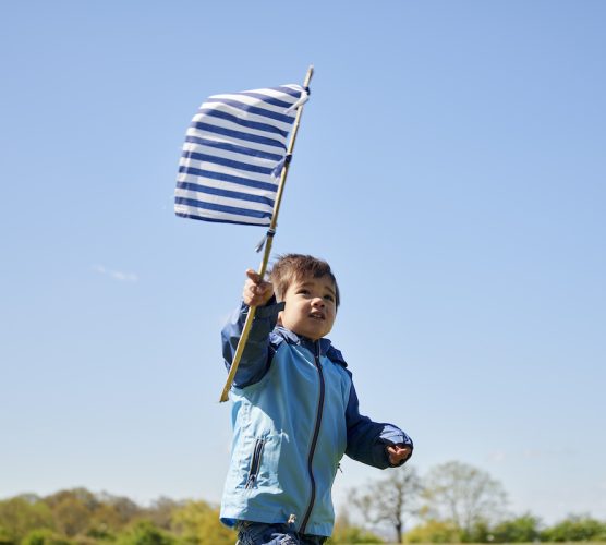 Copy-of-child-runnning-outdoors-with-flag