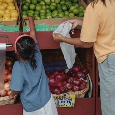 child and parent at food stall