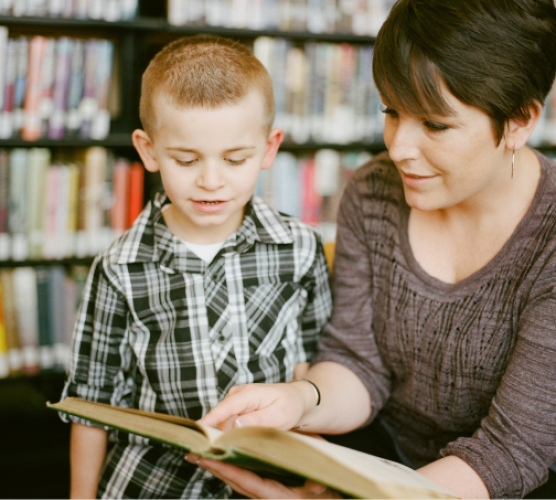 Ofsted childminder showing a child a book