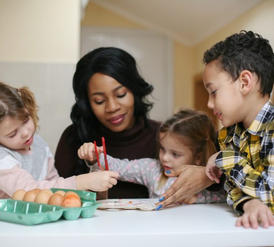 Woman with three child. African American woman with three child prepare for Easter.