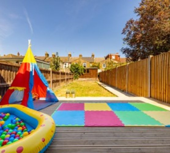 outdoor play space with teepee ball pit and mat